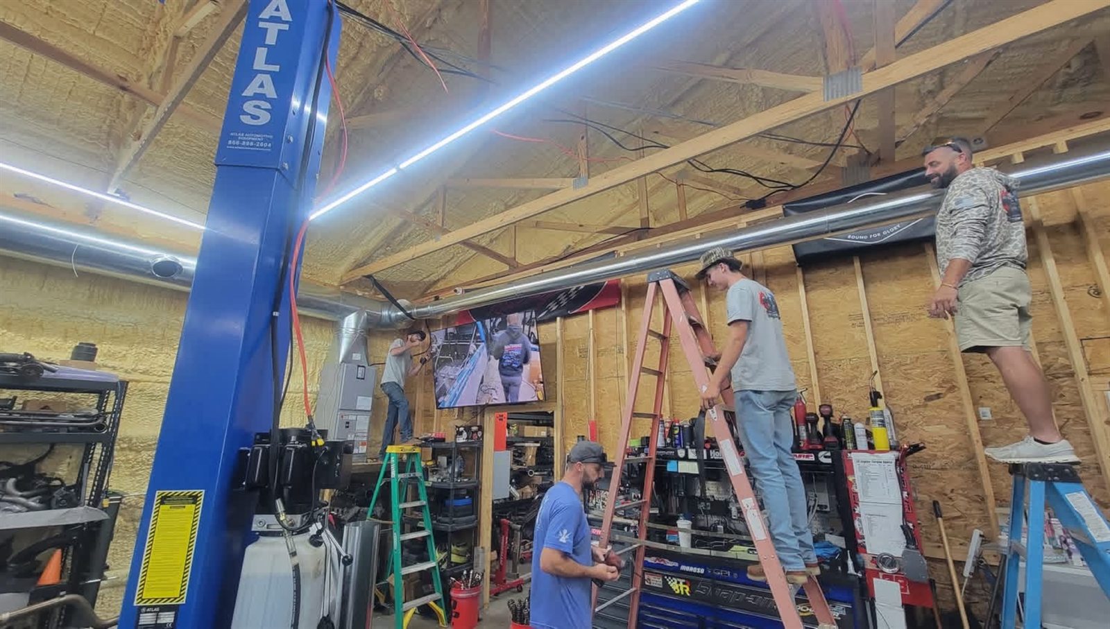 Ascend HVAC team installing exposed ductwork inside a shop