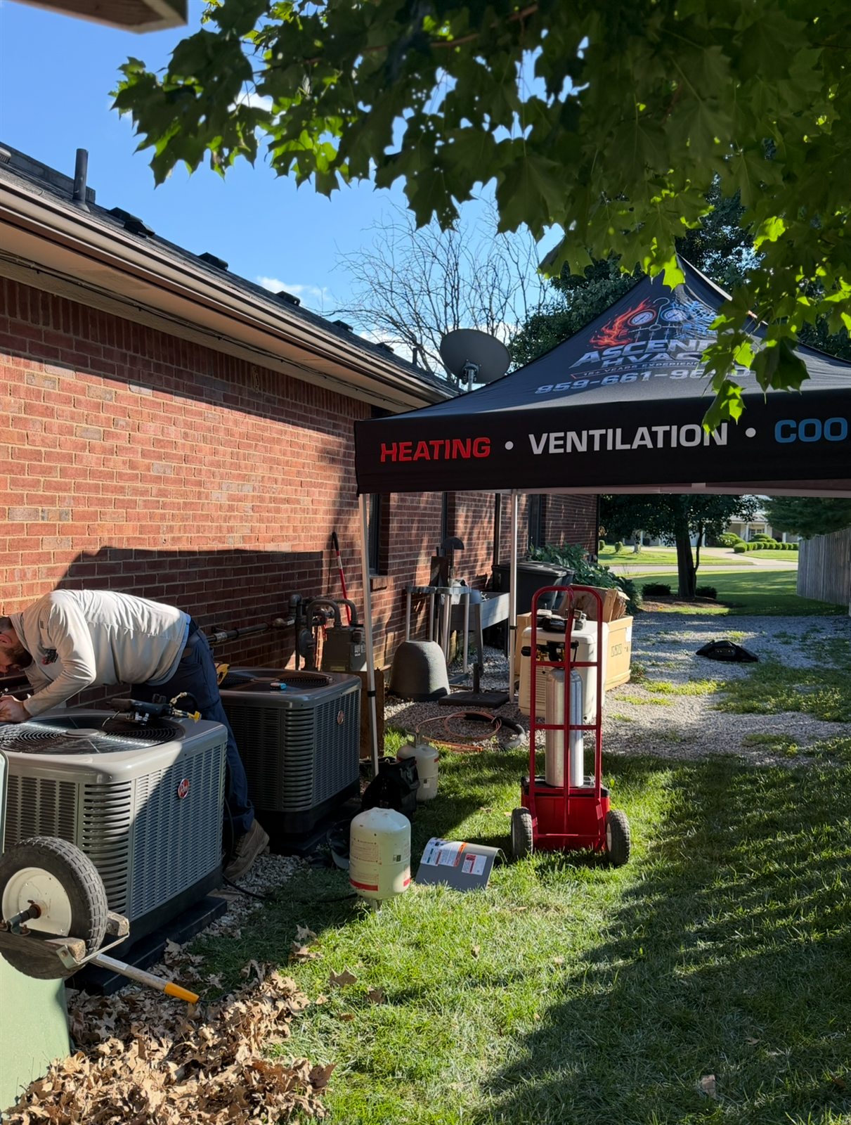 Ascend HVAC technician replacing residential outdoor air conditioning equipment